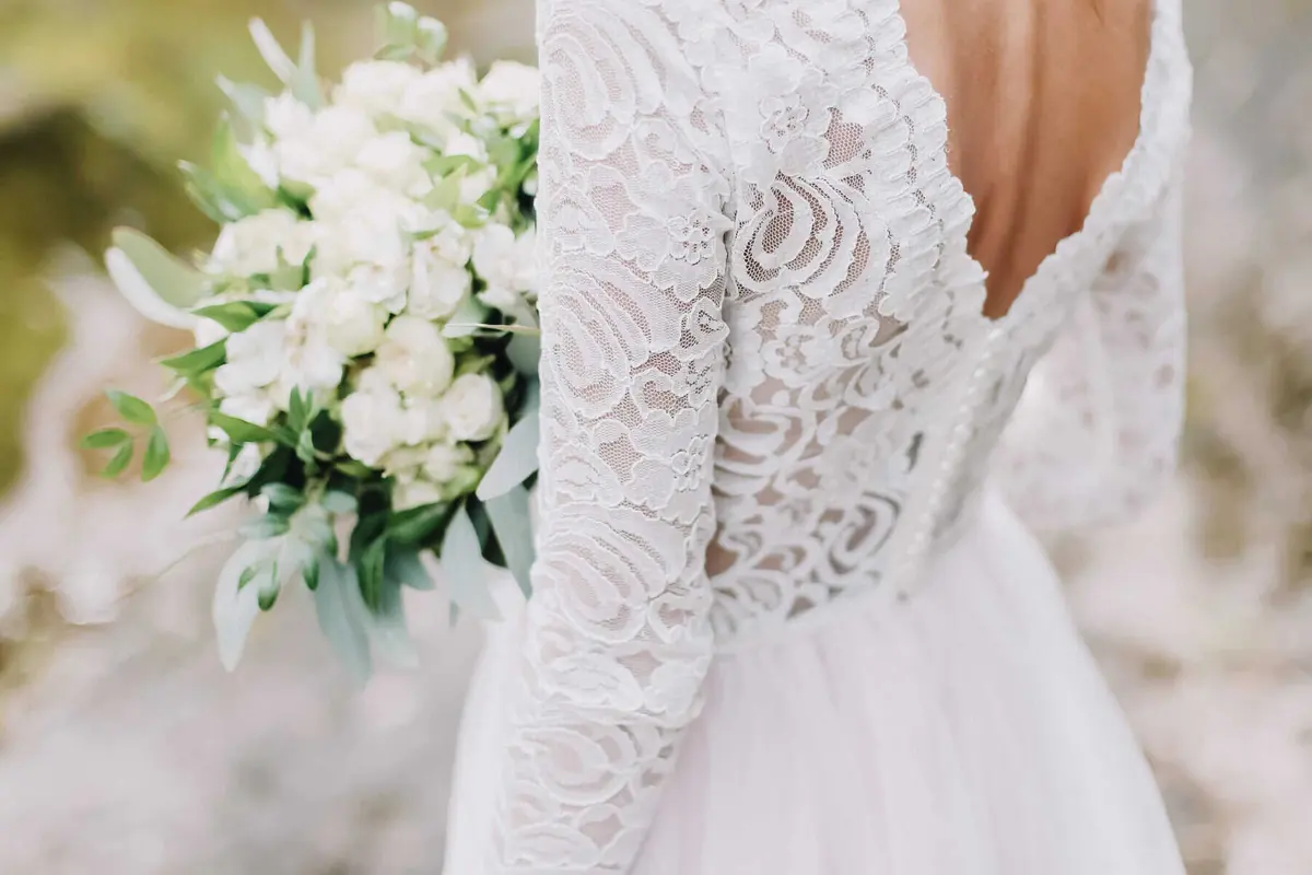 woman wearing preowned wedding dress with lace