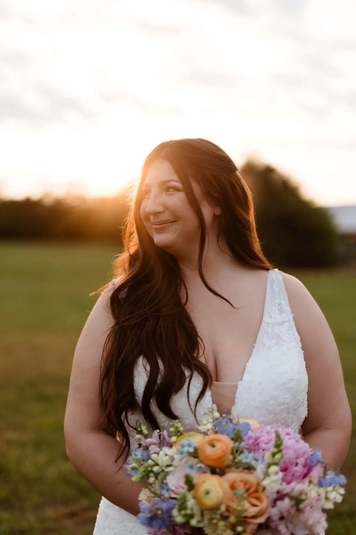 Beautiful bride Madison wearing a romantic lace dress with a deep neckline and figure-flattering silhouette