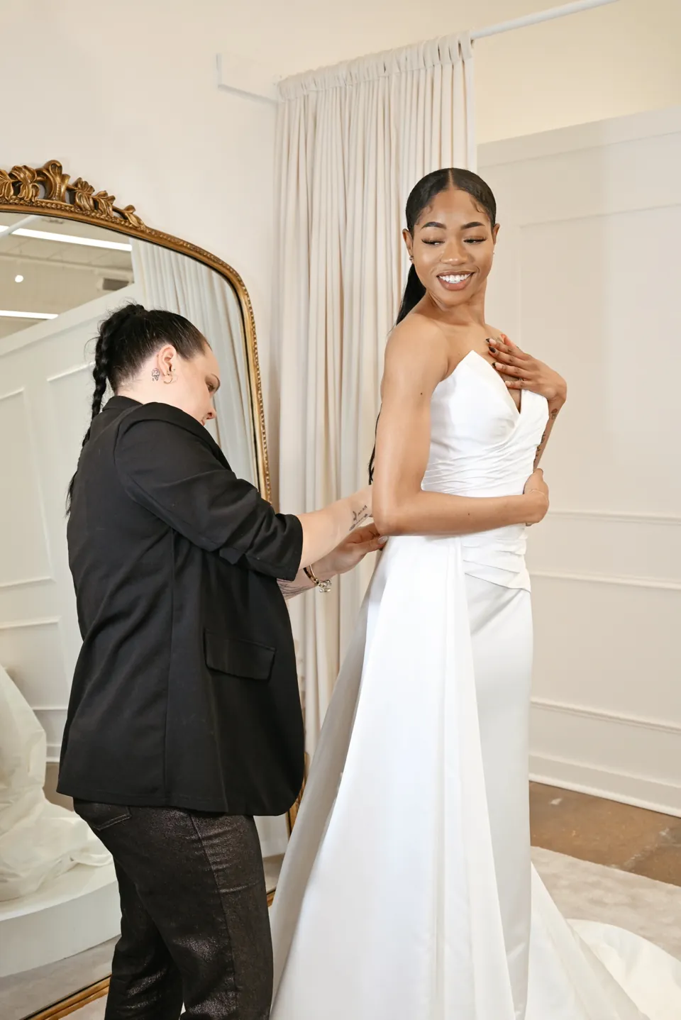 A Savvy Bridal stylist fitting a bride in a private suite