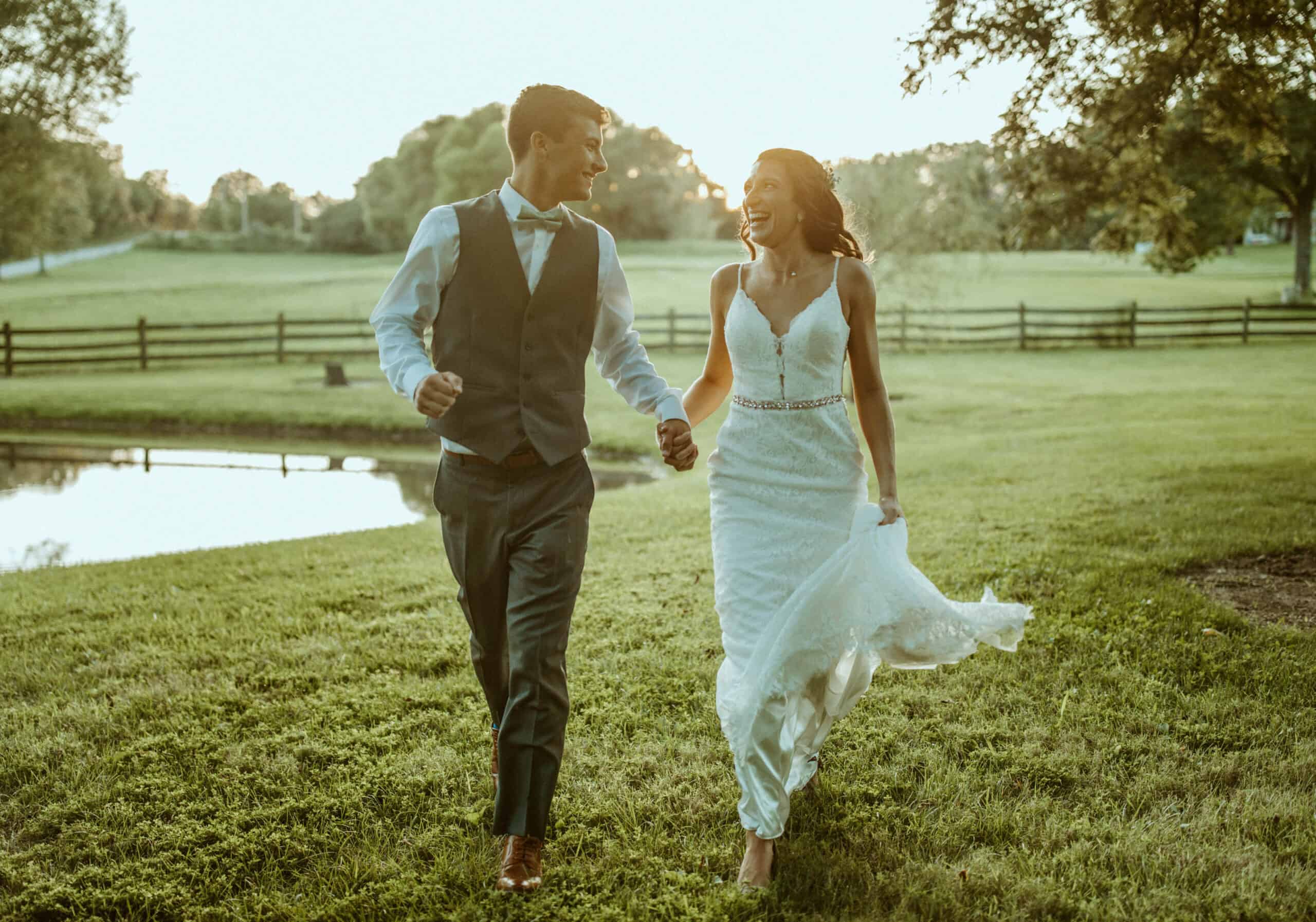 Newlyweds walking through field