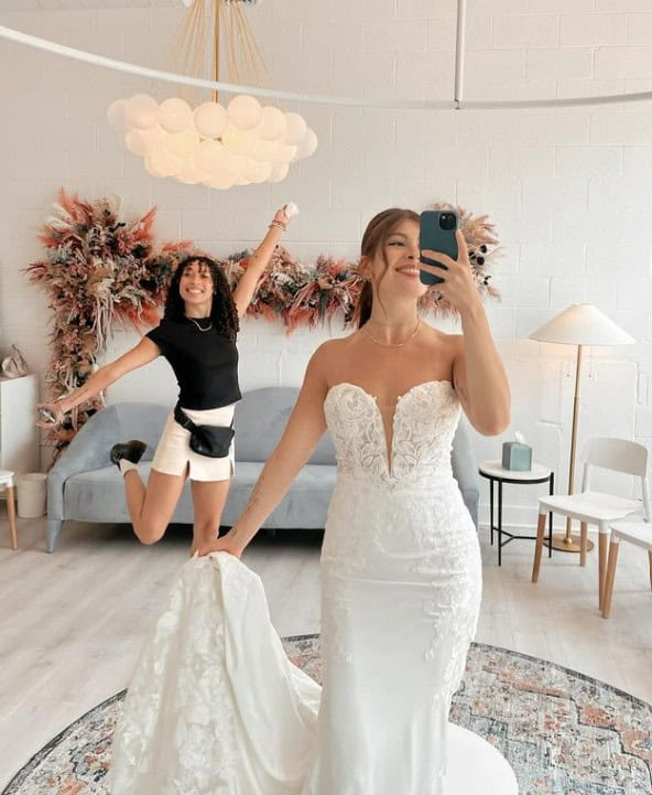 bridal stylist and bride-to-be posing in mirror