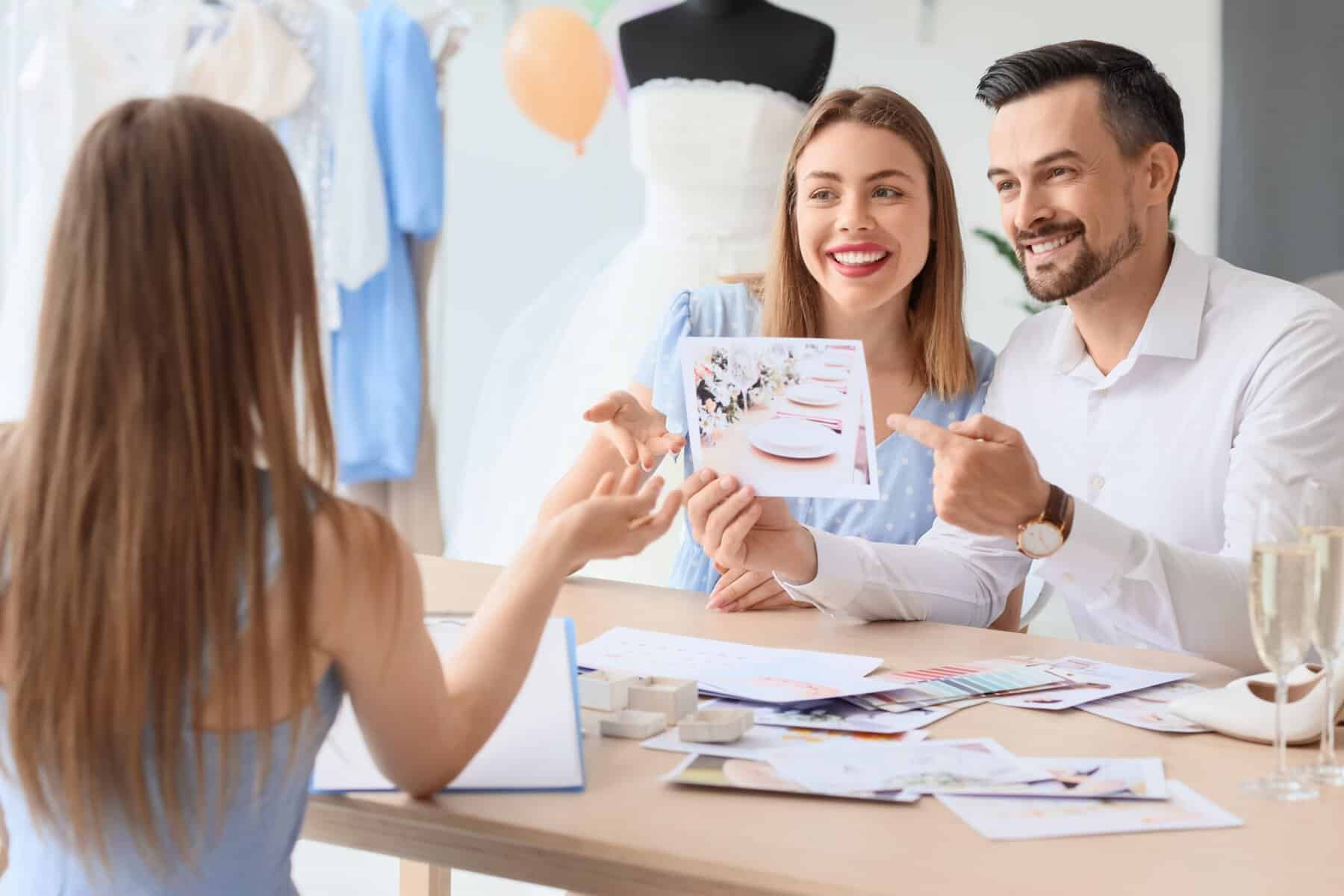 wedding planner sitting with couple at a table