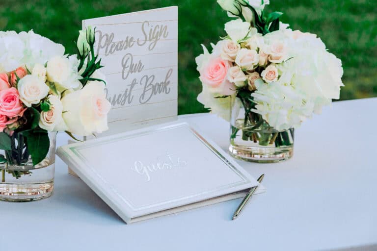 wedding guestbook on table surrounded by flowers