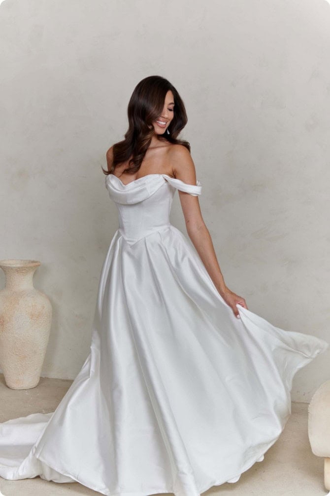 bride wearing satin wedding dress with relaxed shoulder straps