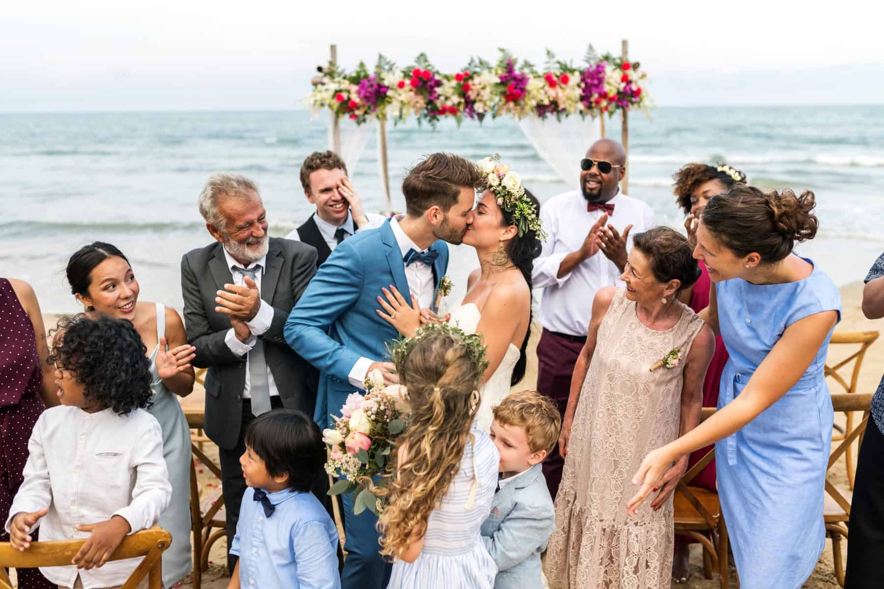 bride and groom surrounded by wedding guests