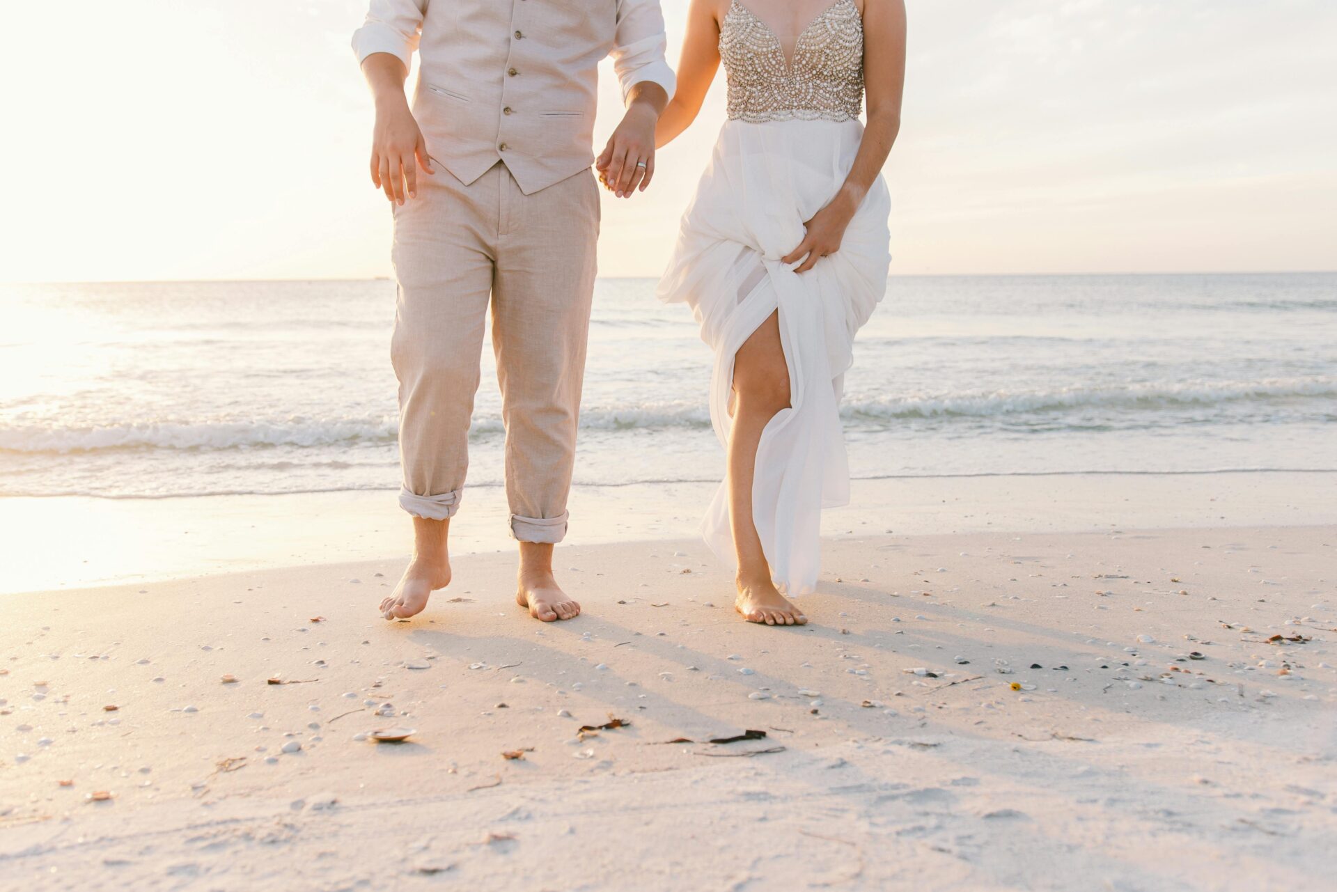 couple barefoot walking on the beach