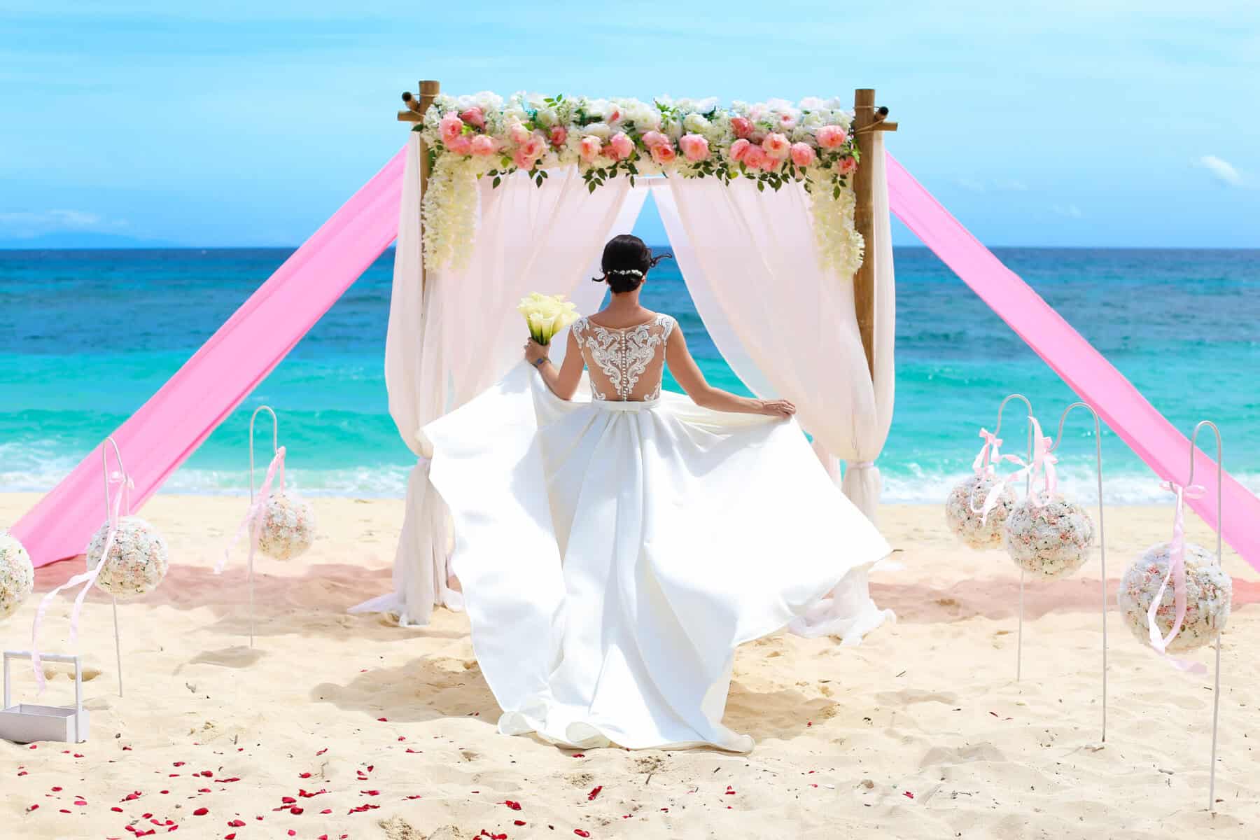 bride wearing summer wedding dress on beach