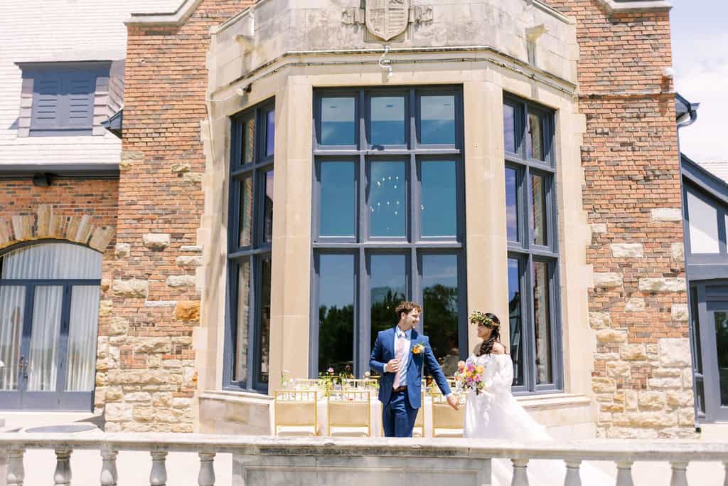 image of a bride and groom holding hands at outdoor venue.