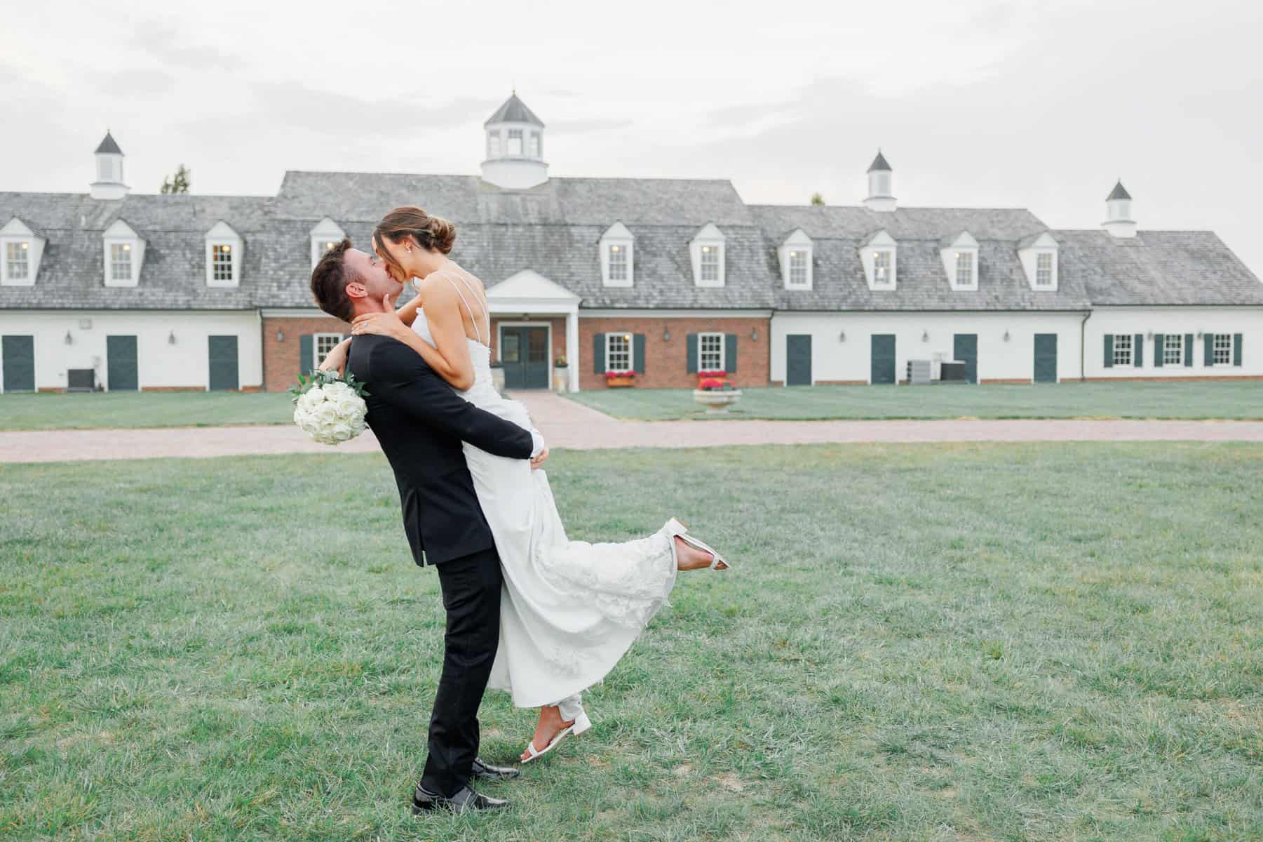 an image of a groom lifted his bride on the air for a romantic and playful embrace.