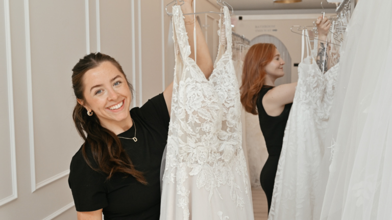 stylist holding a bridal gown