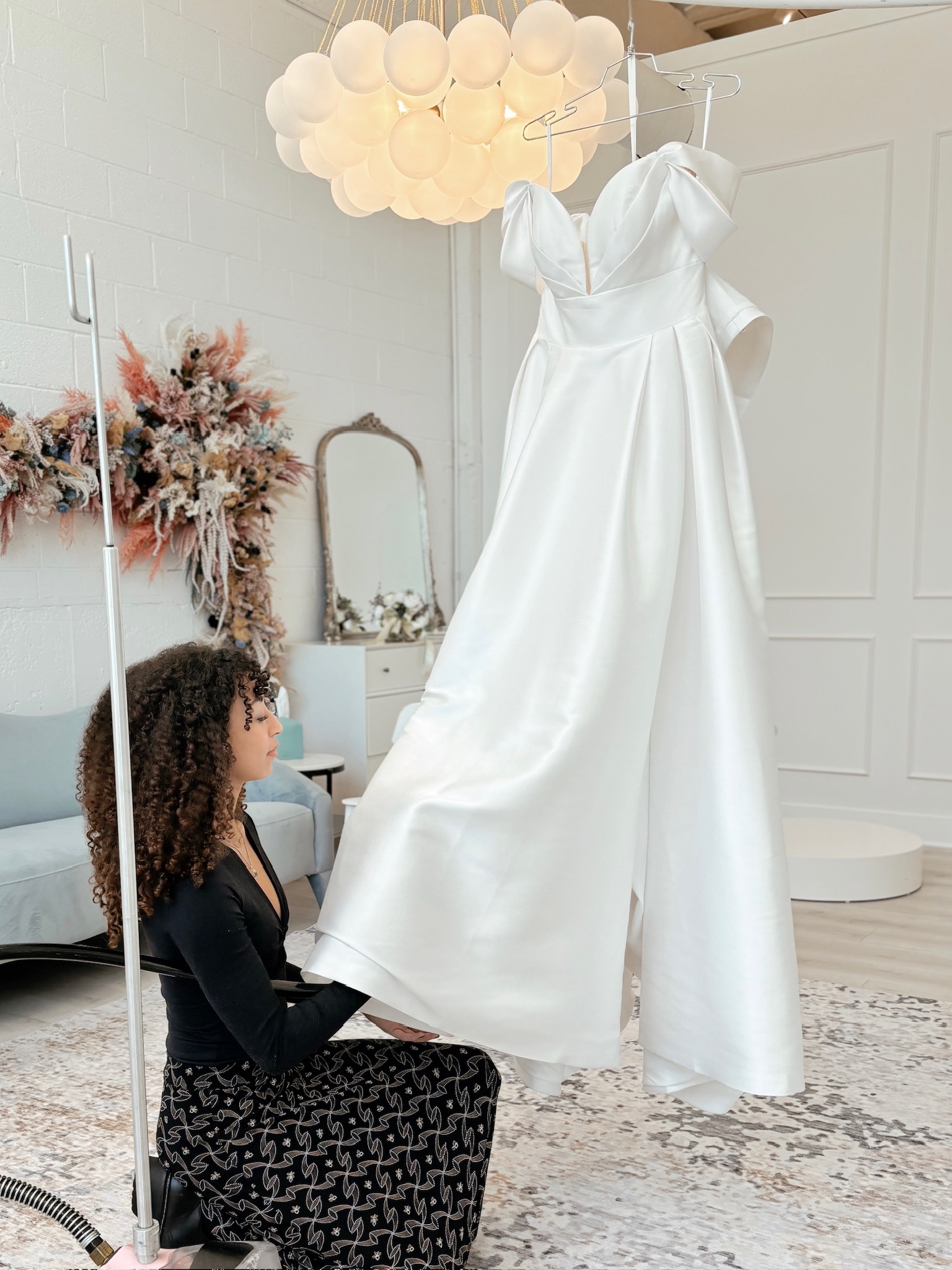 stylist steaming the dress