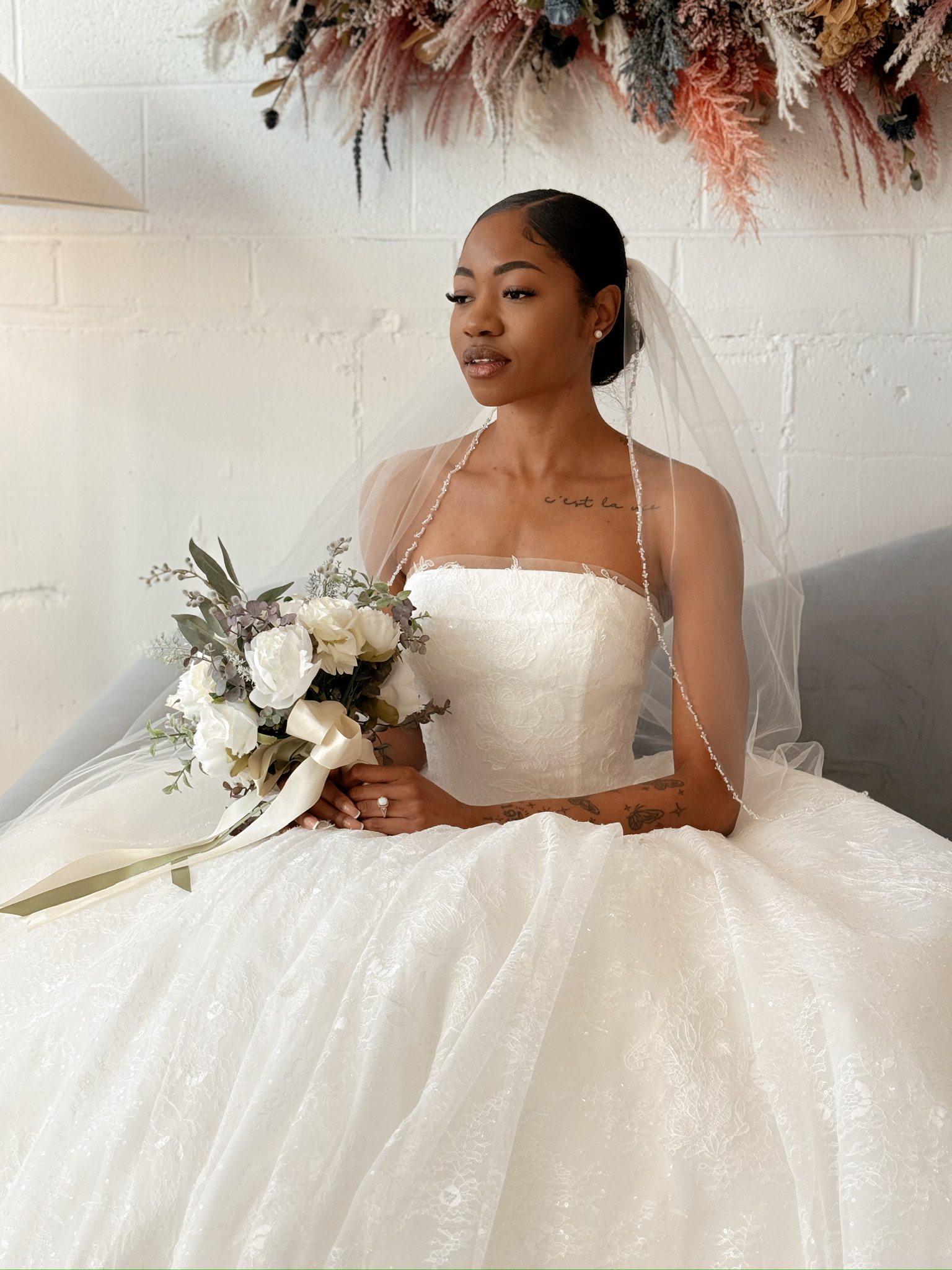 Athena by Bella Luna Bridal paired with veil and bouquet to complete the look.