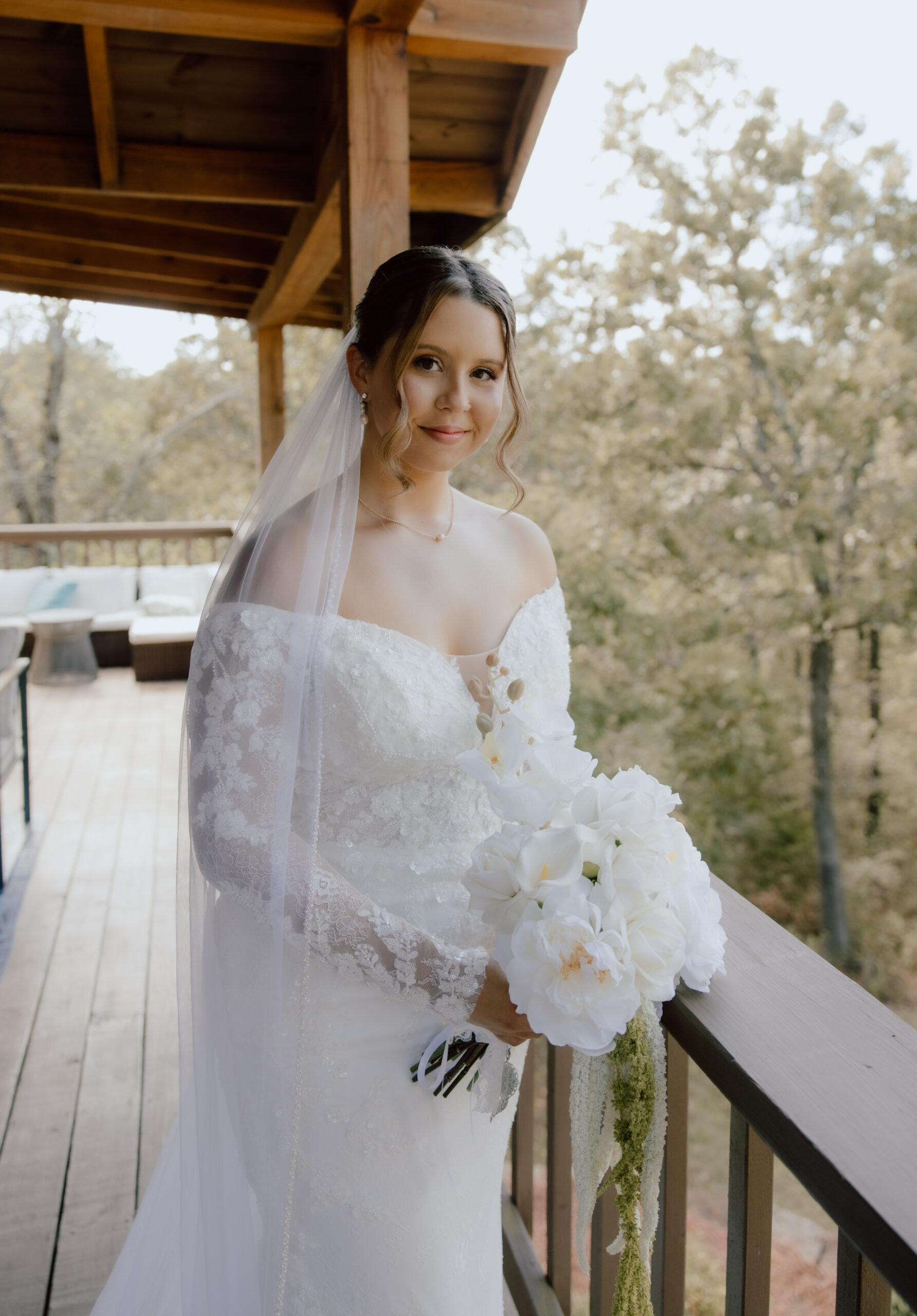 The bride wearing a stunning off-the-shoulder lace gown