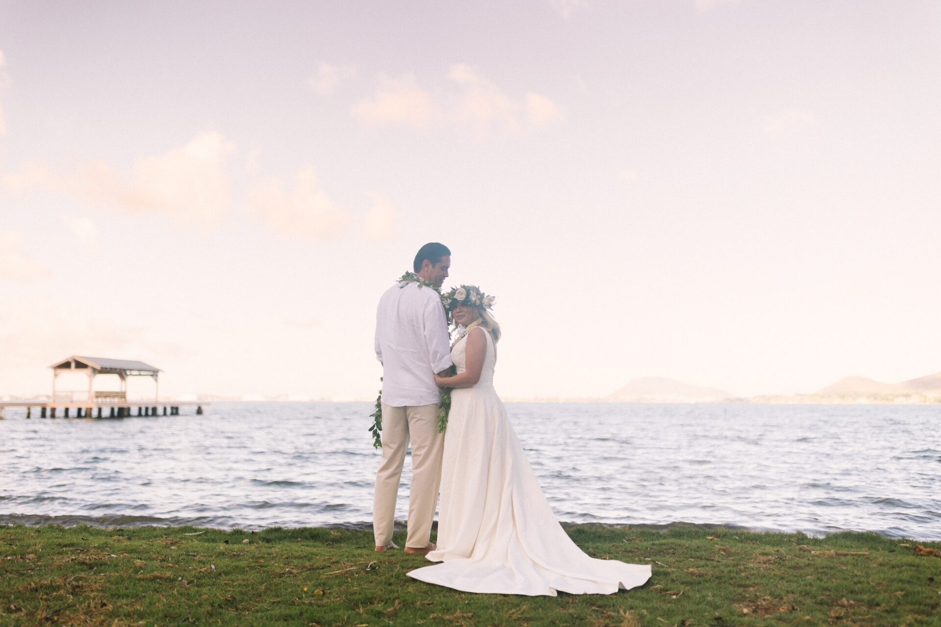 Image of the couple with beautiful background of warm ocean breezes, vibrant greenery, and breathtaking island views