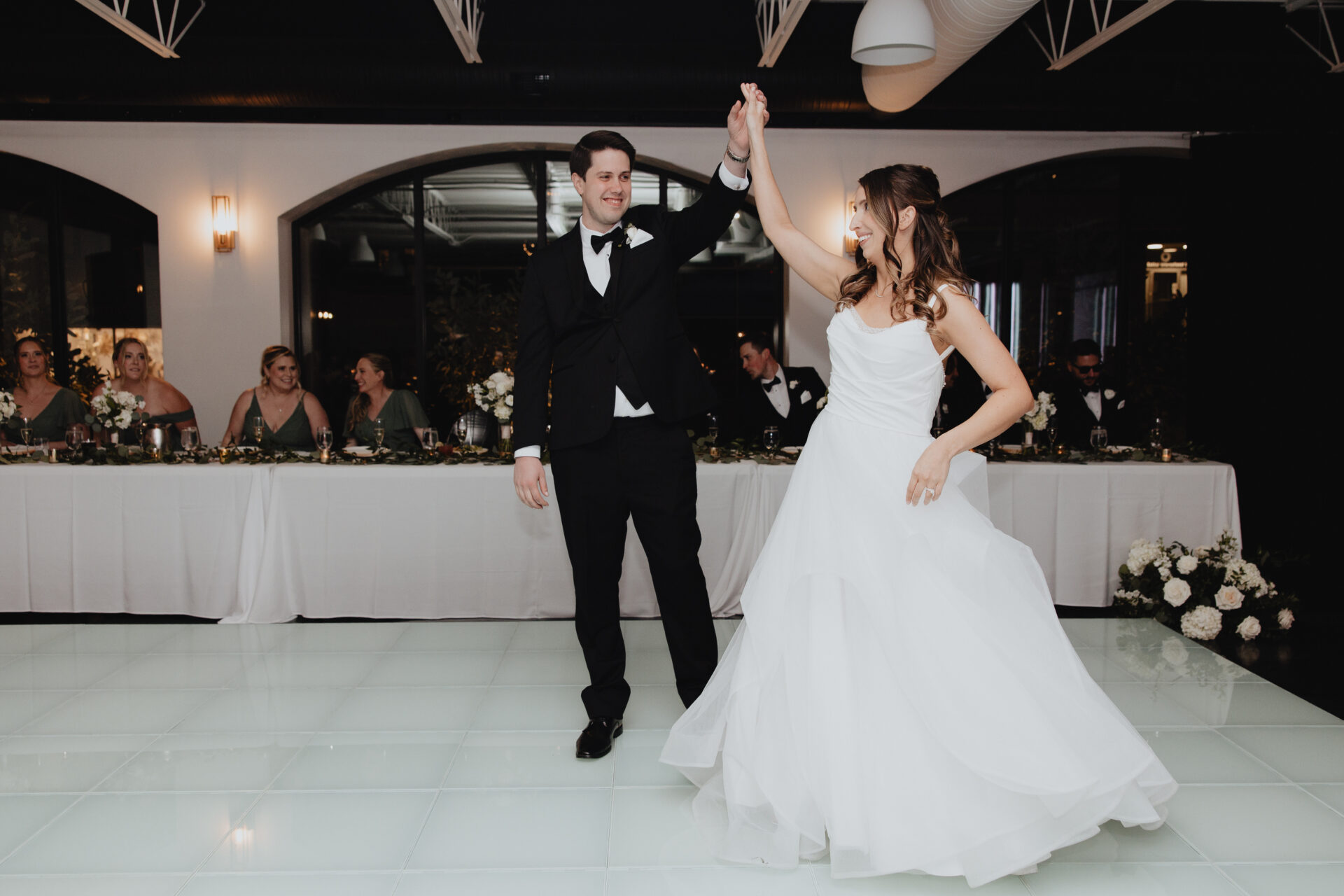 The couple’s first dance. Dave twirling Caroline as the layered skirt of her gown caught the light.