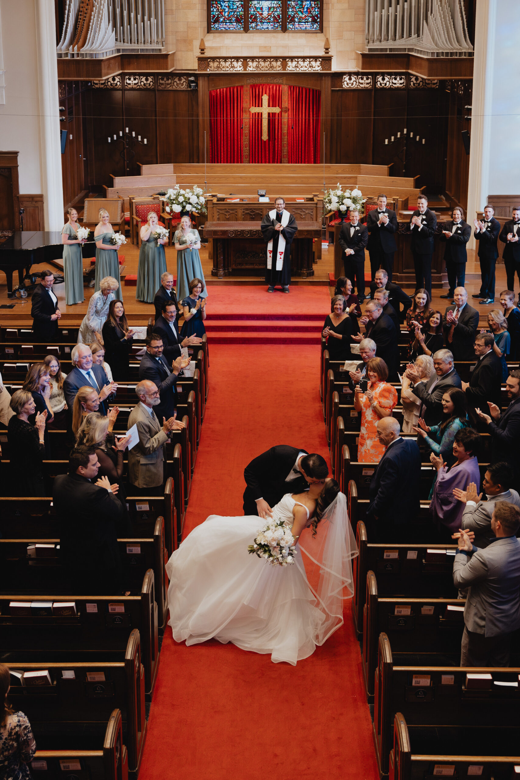 Dave swept Caroline into a dramatic, romantic dip-kiss right in the center of the aisle