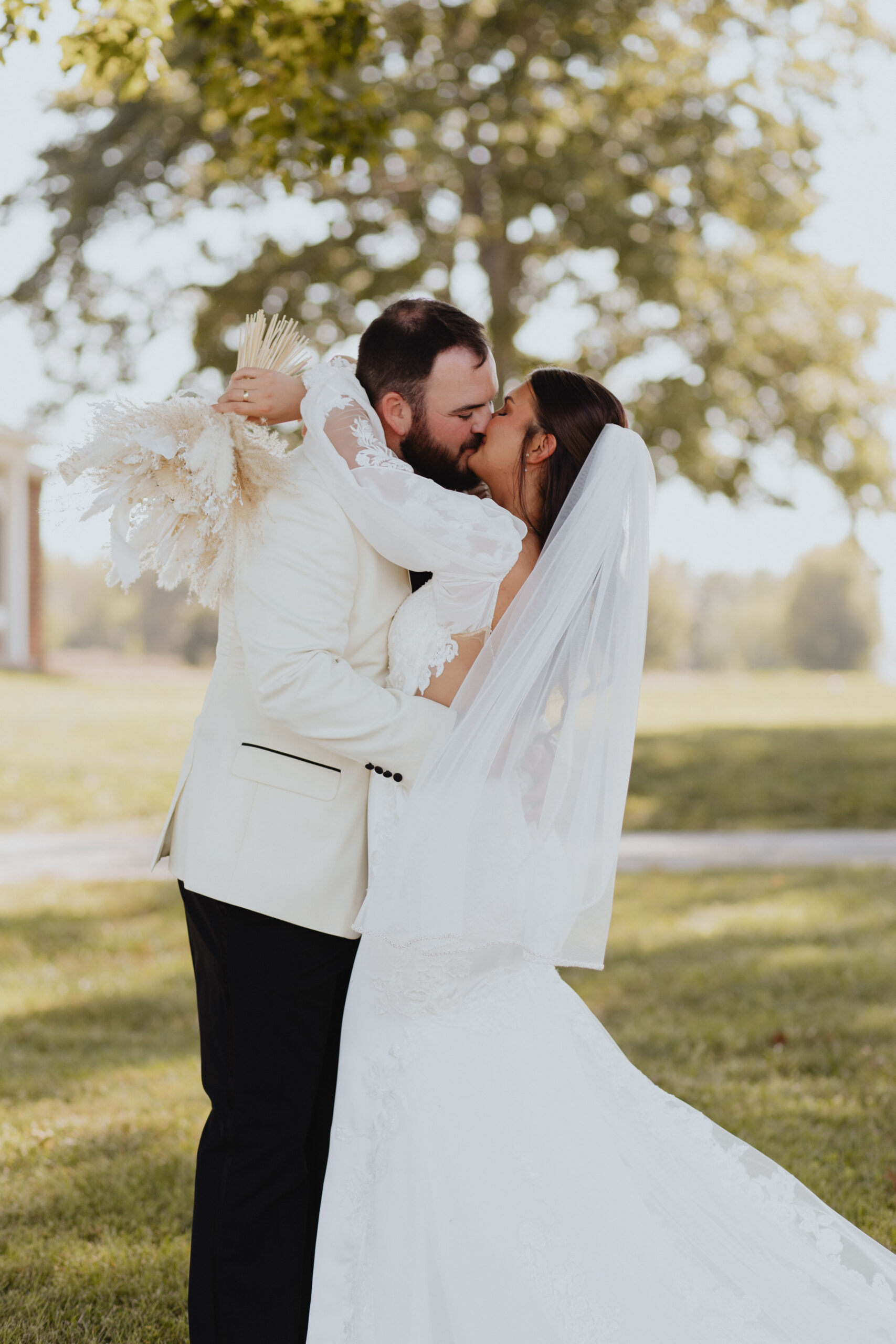 Kelsey and Colby’s portraits in the field shared intimate kiss.