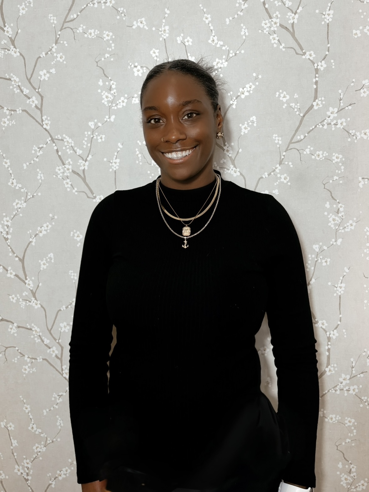 STL stylist Kamille on flower wall