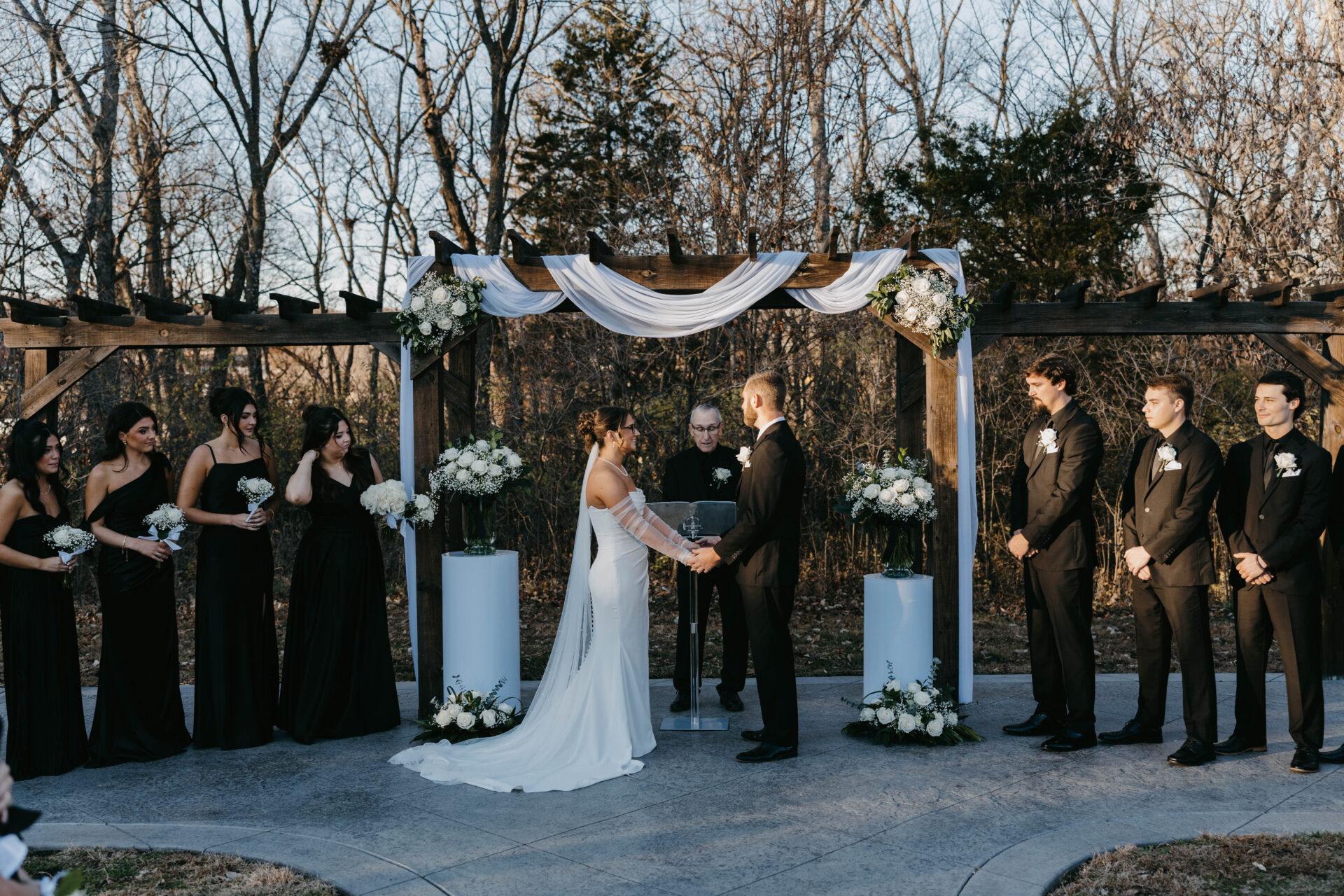 wedding day ceremony unfolded beneath a canopy of copper-toned oaks and endless blue sky