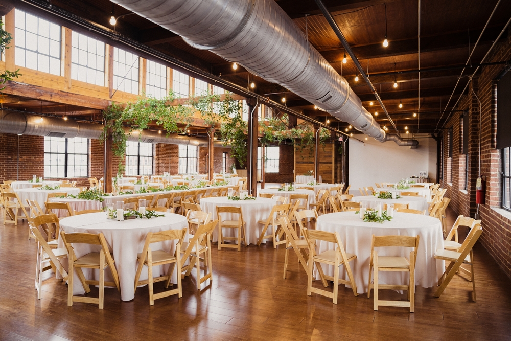 Industrail warehouse wedding reception tablescapes with white tables