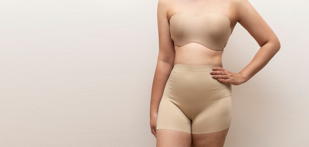 a woman in nude-colored wedding shapewear