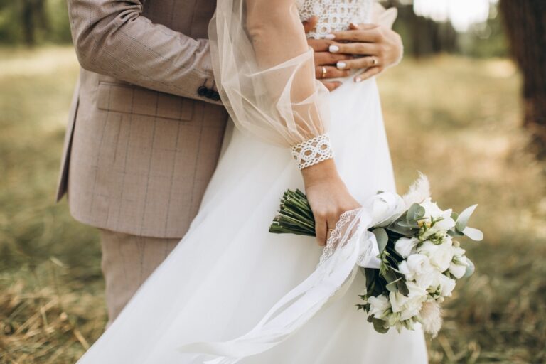 Bride in a spring wedding dress with flowy tulle sleeves