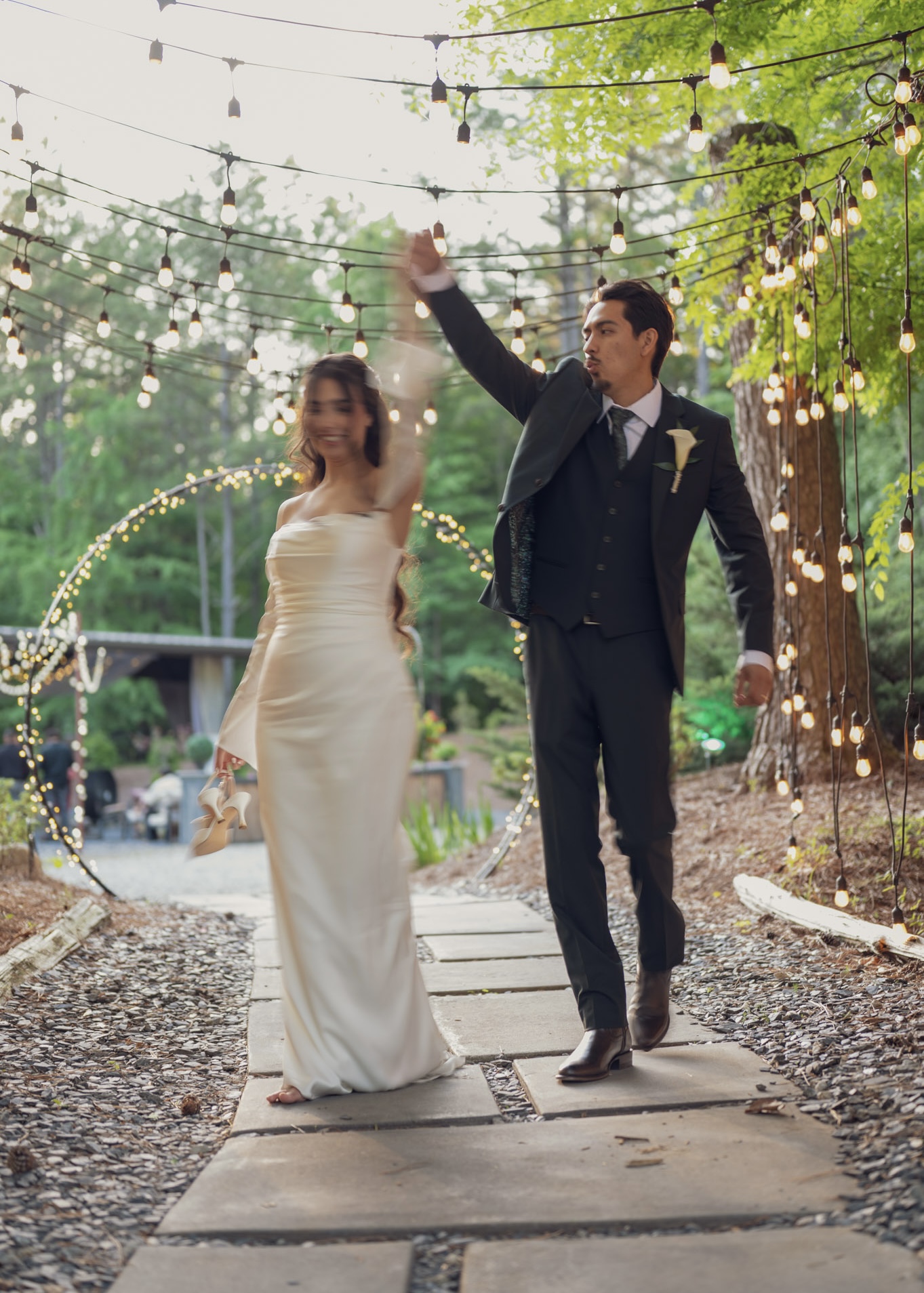 Savvy Bride Brenda and Saul Walking together under the string light