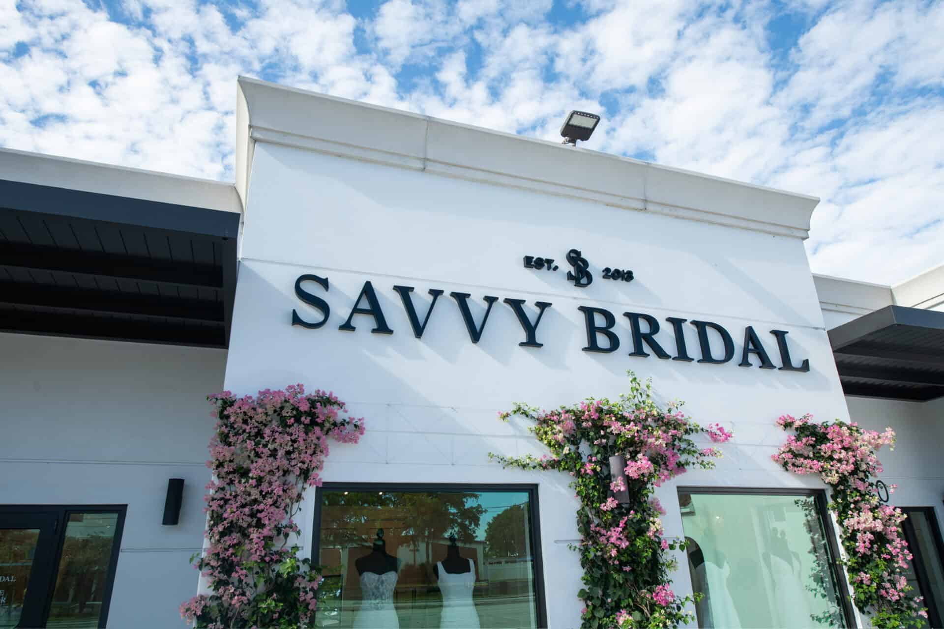 Savvy Bridal Fort Lauderdale storefront with luxury bridal boutique entrance, floral displays, and designer wedding dresses showcased in the front windows.