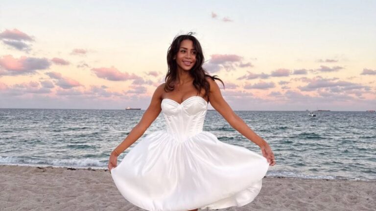 Bride wearing a strapless satin tea-length wedding dress on Fort Lauderdale Beach at sunset.