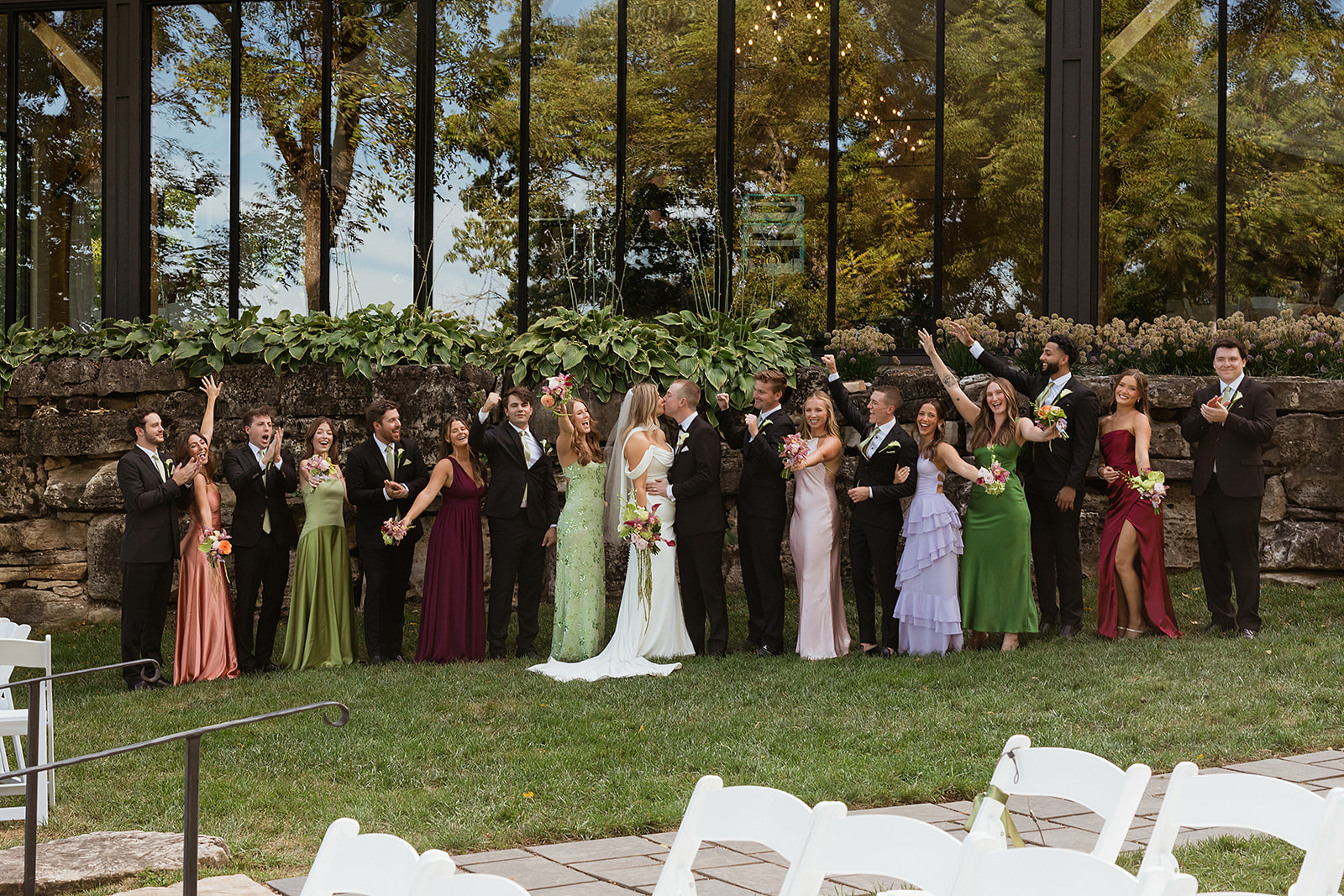 The bridesmaids wore an eclectic combination of green, lavender, burgundy, blush, and floral dresses.