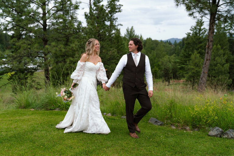 SavvyBride Katrina and Ryon celebrated their June 2026 wedding surrounded by the mountains, pine trees and waters of Flathead Lake. See their romantic Montana wedding and Katrina's stunning floral bridal look.