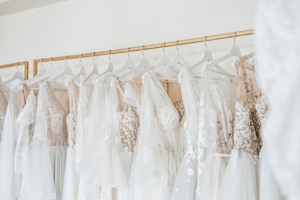 Wedding dress on clothing rack in a showroom or bridal boutique.